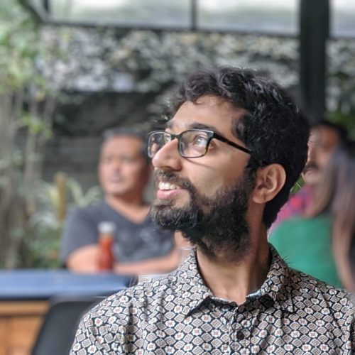 Chinmay Kulkarni looks to the left in a meeting