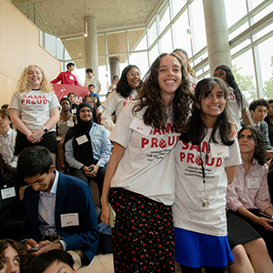 Students hug during SAMS Symposium